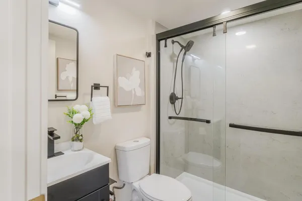 a bathroom with a sink toilet and shower