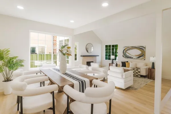 a living room with fireplace furniture and a large window