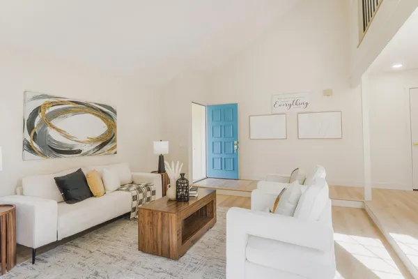 a living room with furniture and a mirror