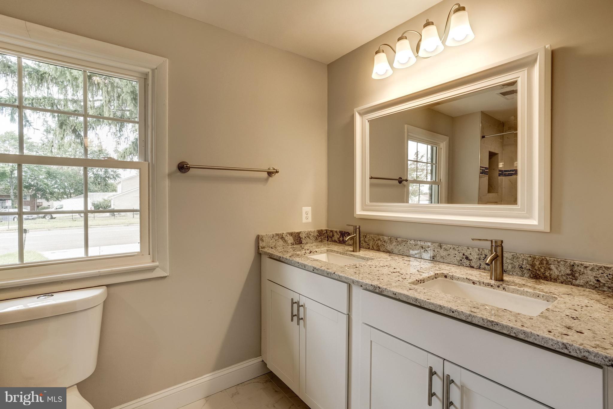 4121 Lees Corner Road Chantilly, VA 20151 - Photo 17 of 28 a bathroom with a granite countertop sink toilet and mirror
