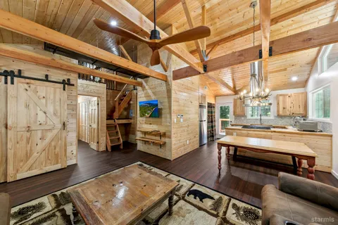 a room with lots of wooden furniture and a table