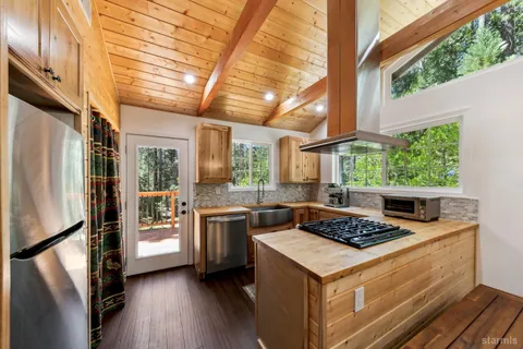 a kitchen that has a sink and a stove