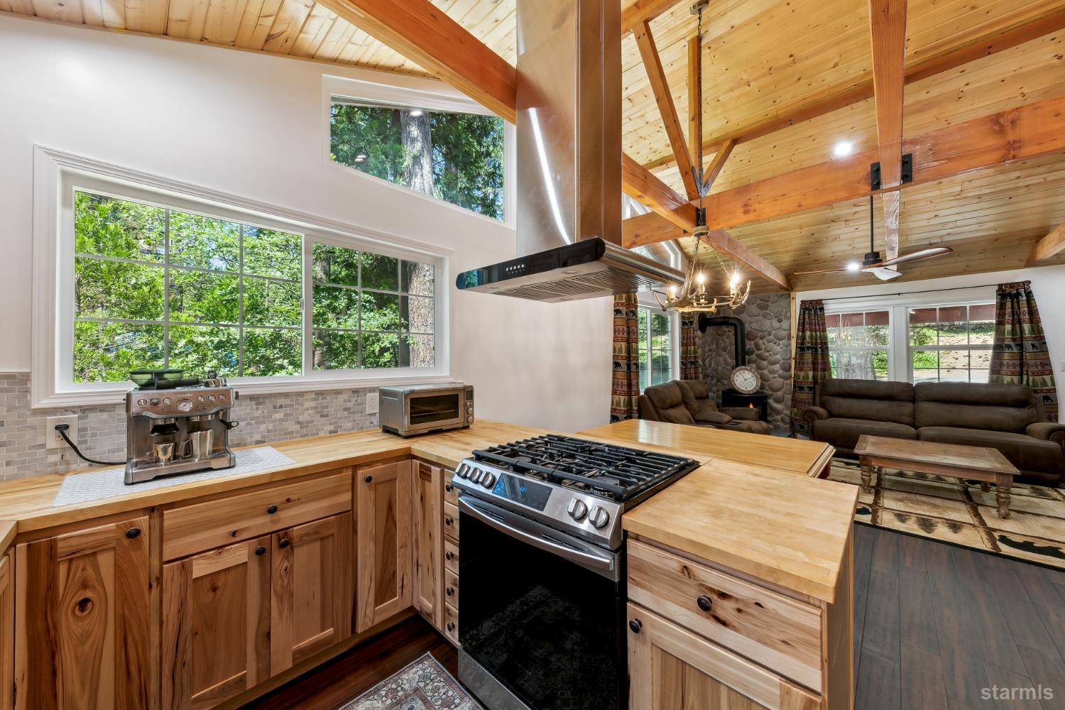 11523 Pickwick Street Kyburz, CA 95720 - Photo 15 of 24 a kitchen that has a sink a stove and a wooden floors