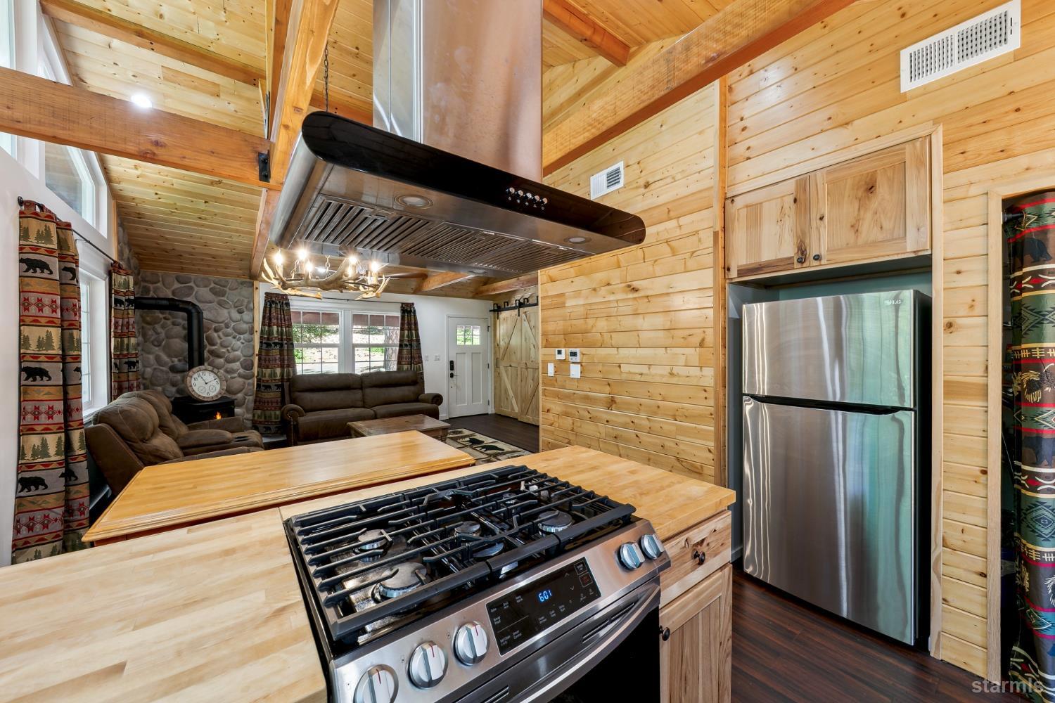 11523 Pickwick Street Kyburz, CA 95720 - Photo 16 of 24 a kitchen with stainless steel appliances granite countertop a refrigerator and a stove top oven
