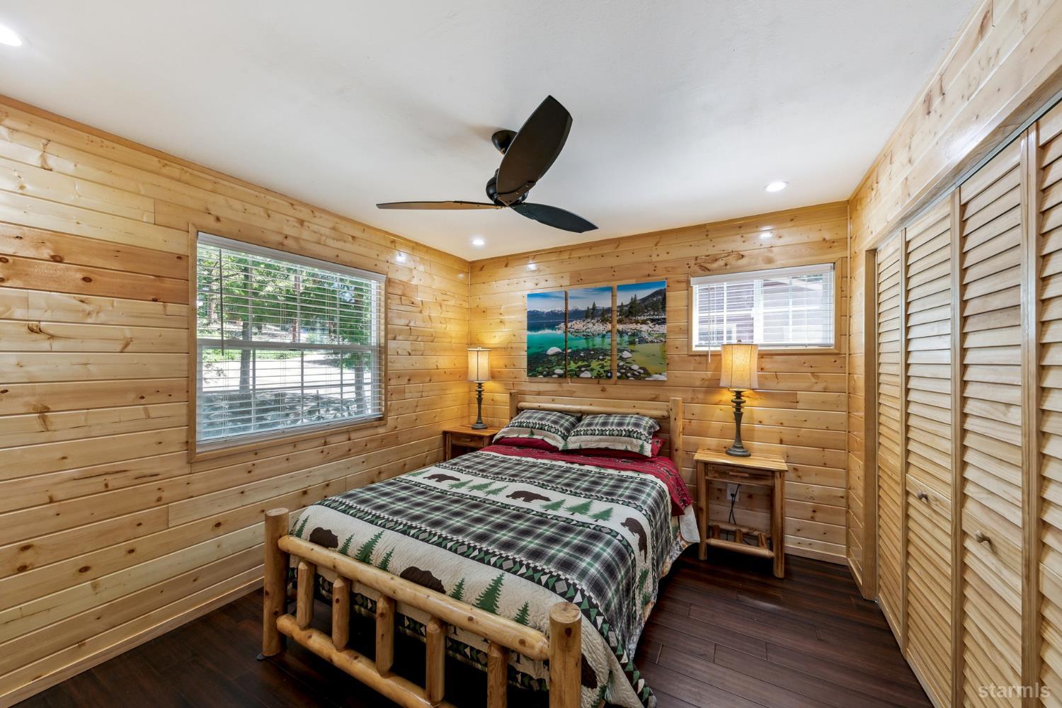 11523 Pickwick Street Kyburz, CA 95720 - Photo 19 of 24 a bedroom with a bed a dresser next to a window