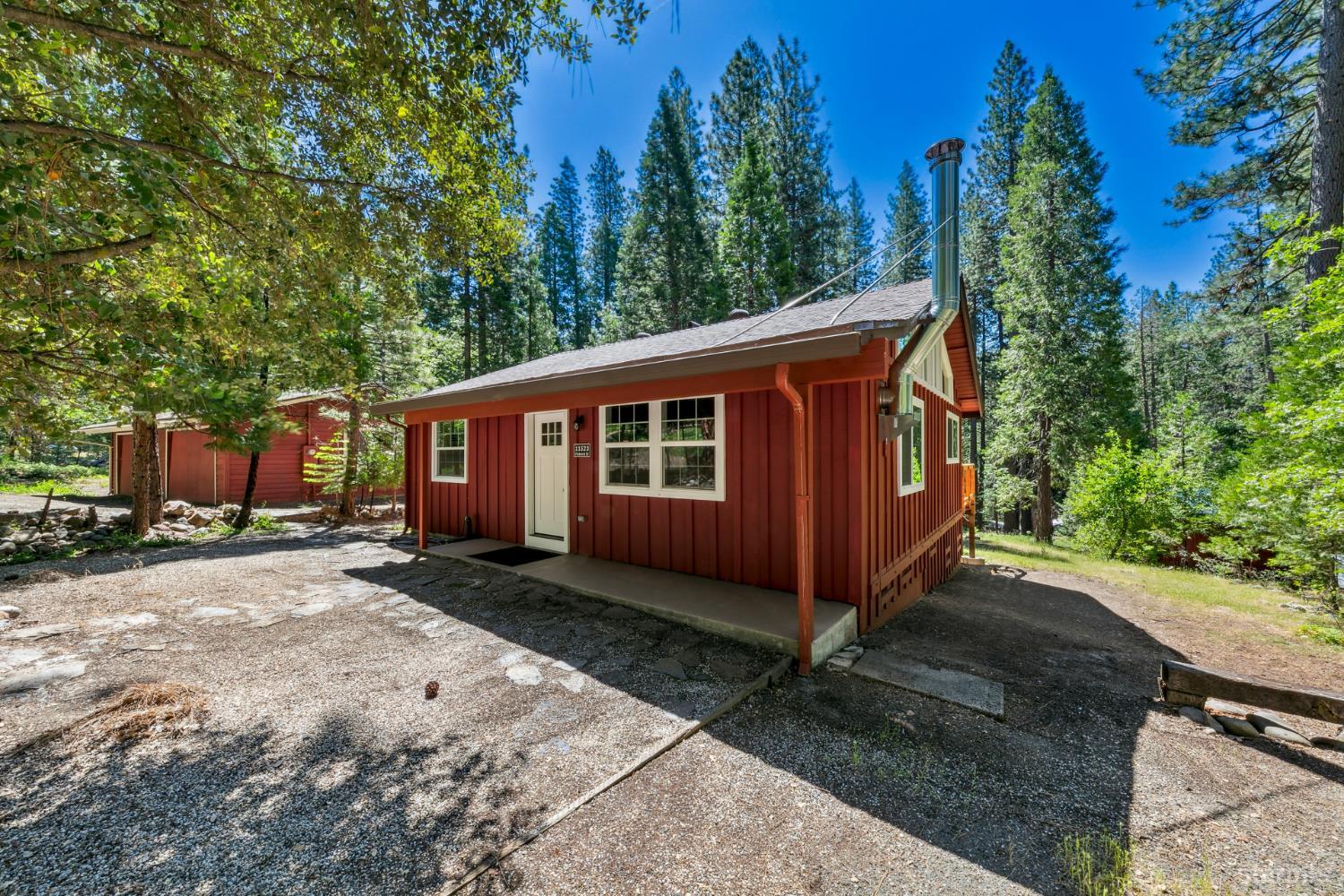 11523 Pickwick Street Kyburz, CA 95720 - Photo 2 of 24 a view of a house with a yard plants and large tree