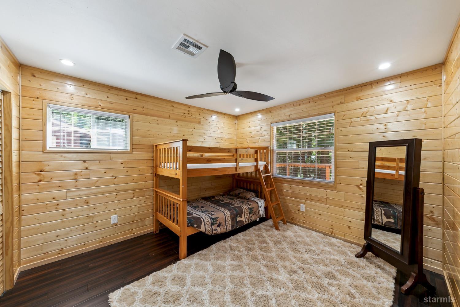 11523 Pickwick Street Kyburz, CA 95720 - Photo 21 of 24 a bedroom with a bed and wooden floor