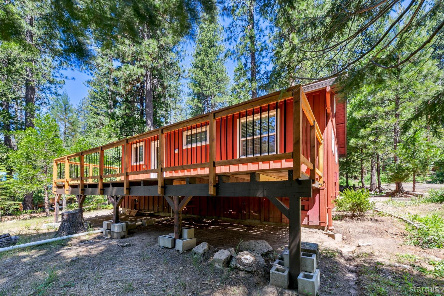11523 Pickwick Street Kyburz, CA 95720 - Photo 3 of 24 a red and white building with a large window and outdoor seating