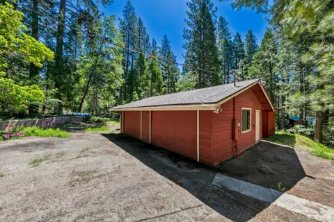 a view of a small yard with wooden fence