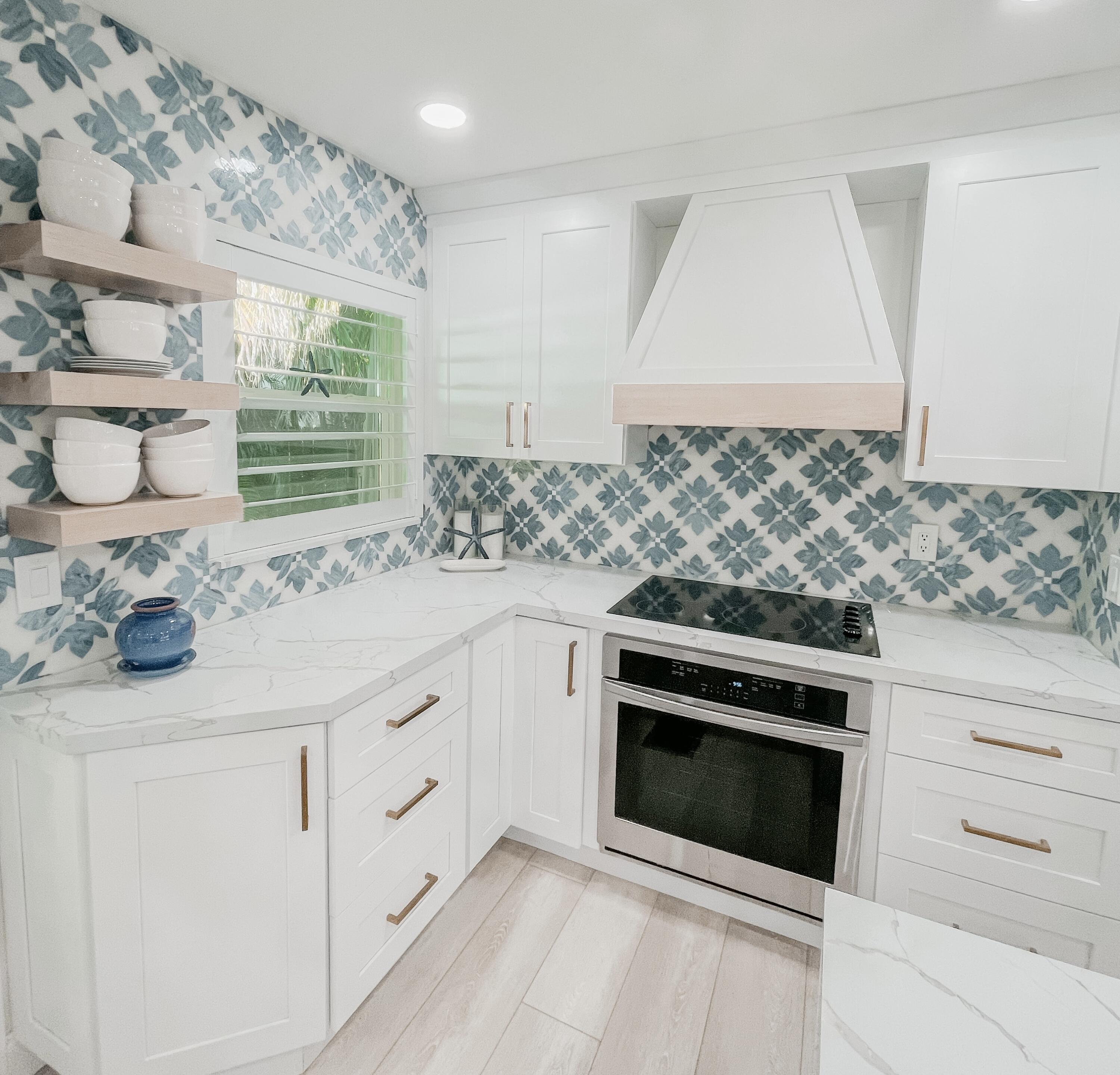 7 Fayette Drive Ocean Ridge, FL 33435 - Photo 11 of 30 a kitchen with white cabinets appliances and a window
