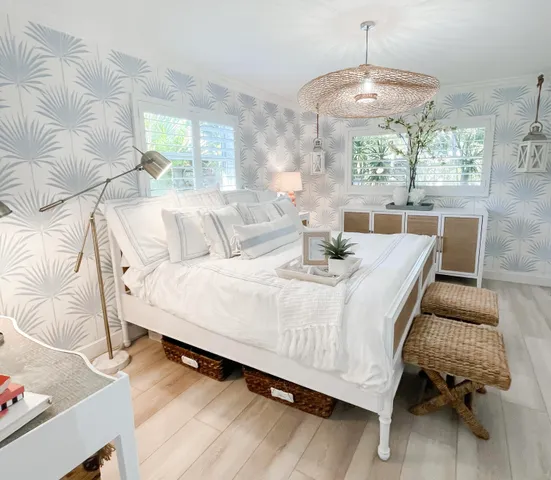 a bed sitting in a bedroom next to a window