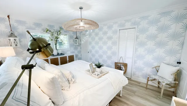 a bedroom with a bed and a chandelier