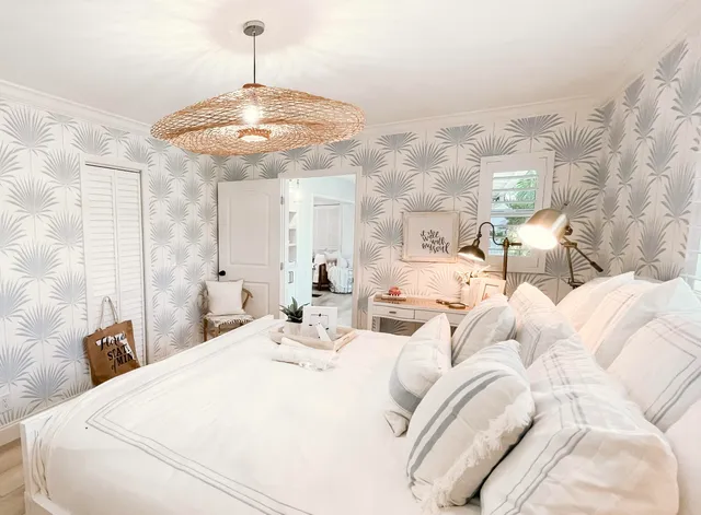 a large bedroom with a bed and a chandelier