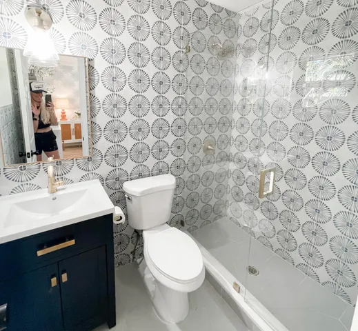 a bathroom with a sink a toilet and a mirror