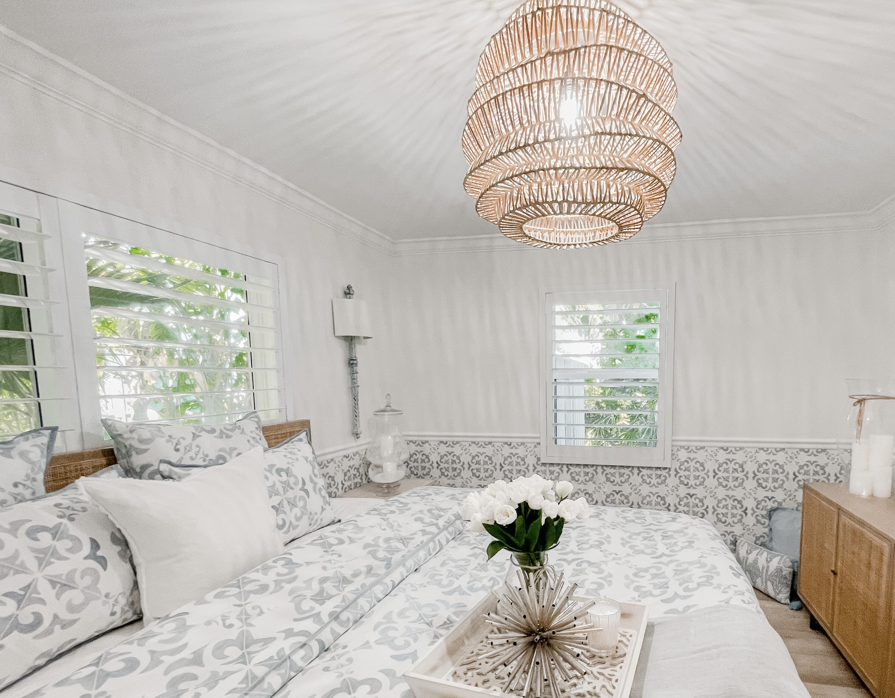 7 Fayette Drive Ocean Ridge, FL 33435 - Photo 24 of 30 a view of a bedroom with a bed and a chandelier