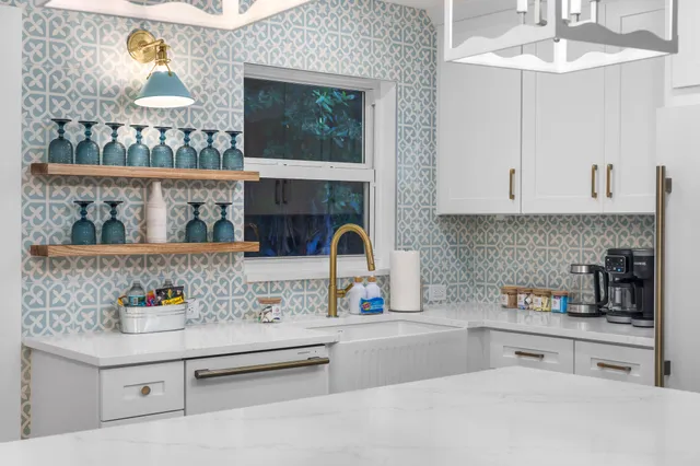 a kitchen with stainless steel appliances a sink and cabinets