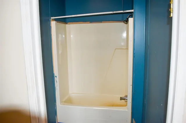 a bathroom with a glass shower door
