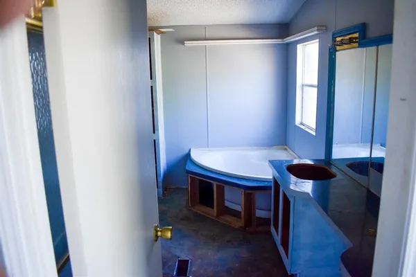 a view of a room that has a table and a chair