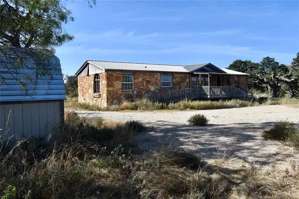 a view of house with a yard