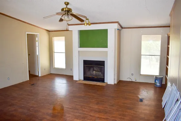 a view of a livingroom with a fireplace and window