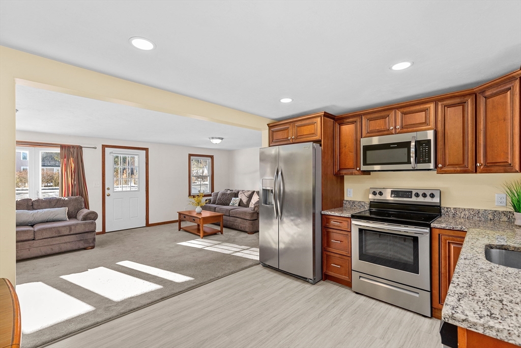 a kitchen with stainless steel appliances granite countertop a refrigerator stove and oven