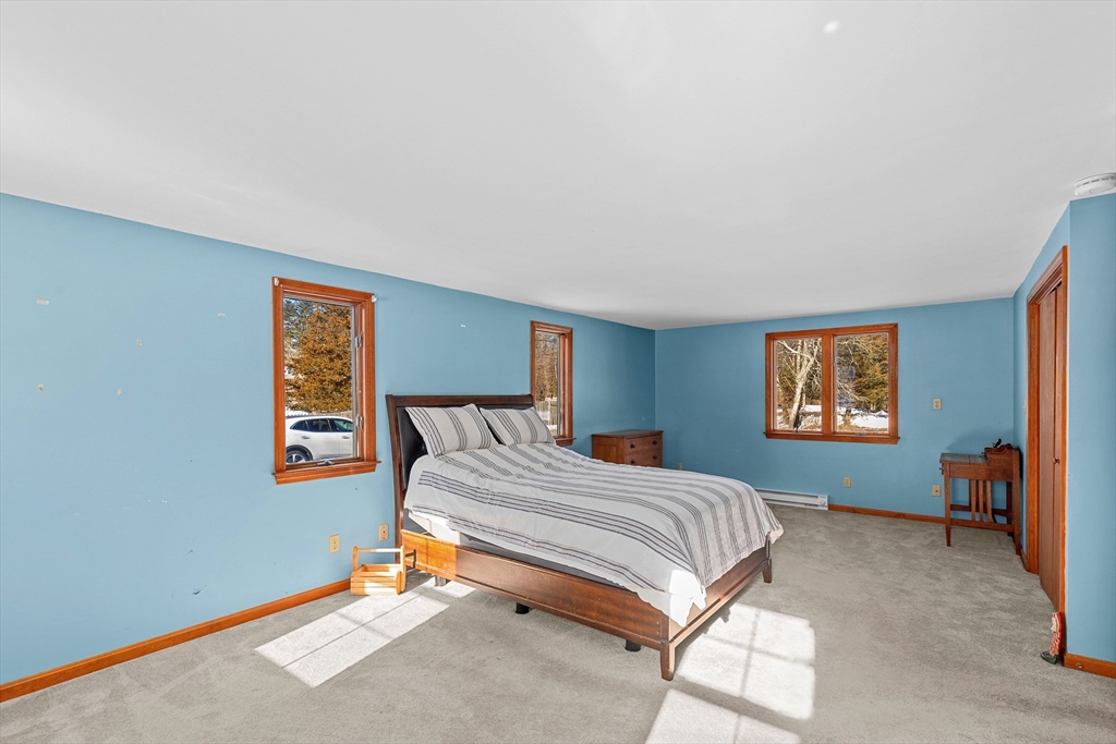 161 Wapping Road Kingston, MA 02364 - Photo 14 of 18 a bedroom with a bed and chair