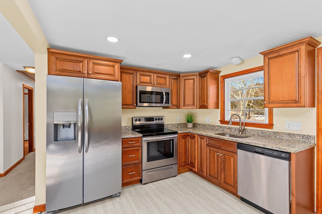 161 Wapping Road Kingston, MA 02364 - Photo 2 of 18 a kitchen with stainless steel appliances granite countertop a refrigerator a sink a stove a washer dryer and cabinets