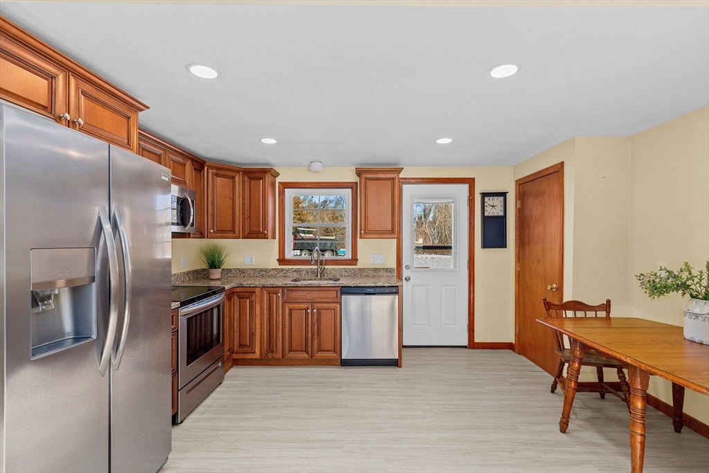 161 Wapping Road Kingston, MA 02364 - Photo 5 of 18 a kitchen with stainless steel appliances granite countertop a refrigerator a stove and a sink