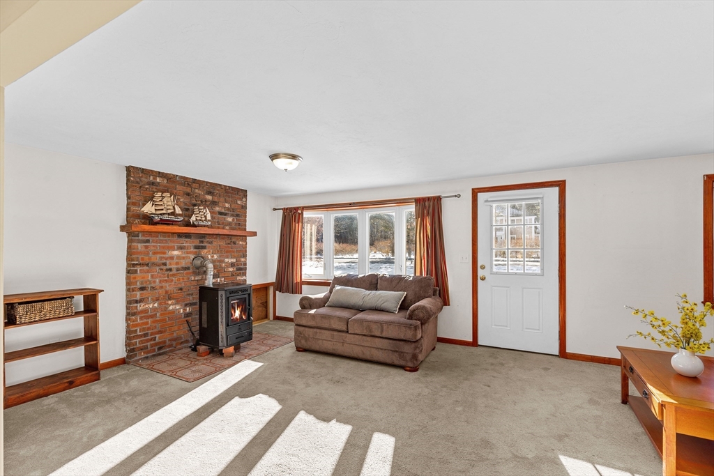 161 Wapping Road Kingston, MA 02364 - Photo 8 of 18 a living room with furniture and a fireplace