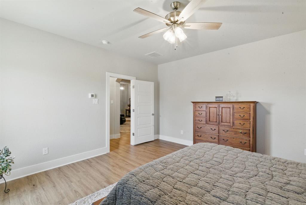 247 Gopher Road Weatherford, TX 76088 - Photo 15 of 35 a bedroom with a bed and a dresser
