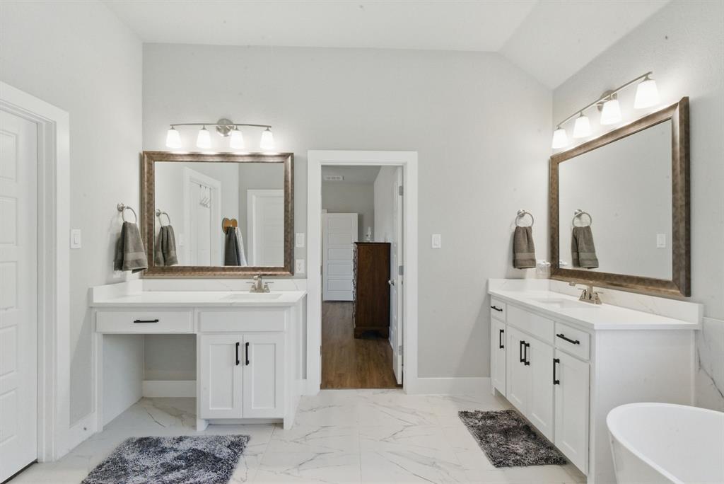 247 Gopher Road Weatherford, TX 76088 - Photo 16 of 35 a spacious bathroom with a double vanity sink and a mirror