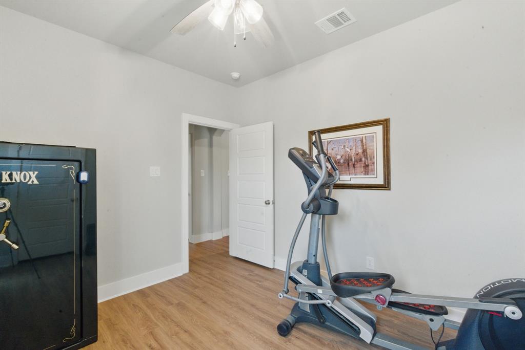 247 Gopher Road Weatherford, TX 76088 - Photo 26 of 35 a room with gym equipment and wooden floor