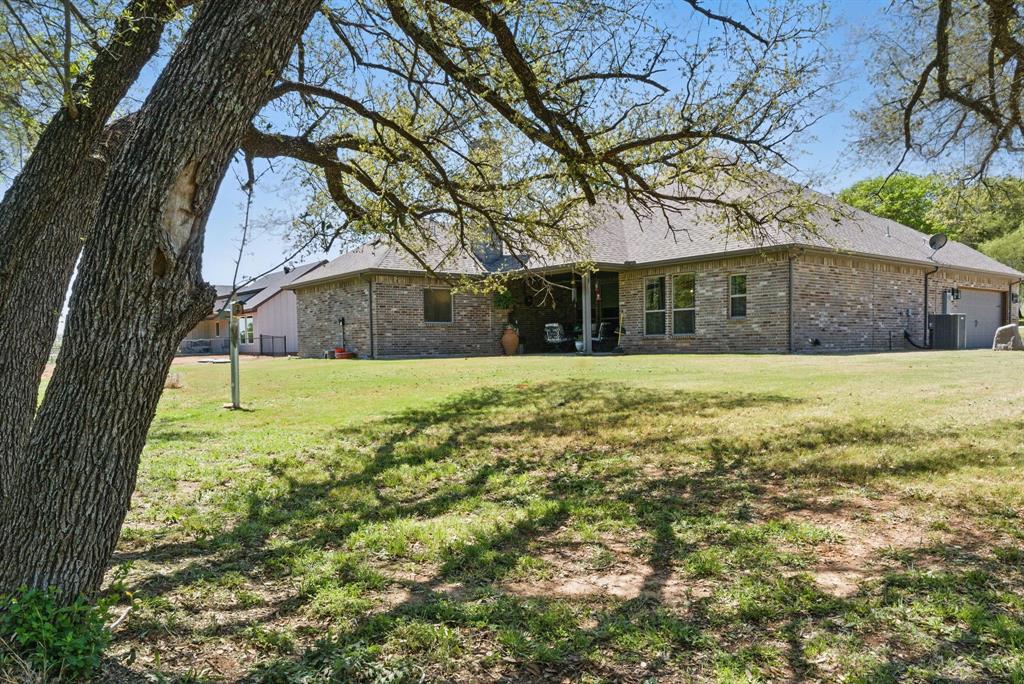 247 Gopher Road Weatherford, TX 76088 - Photo 30 of 35 a view of a white house with a large trees