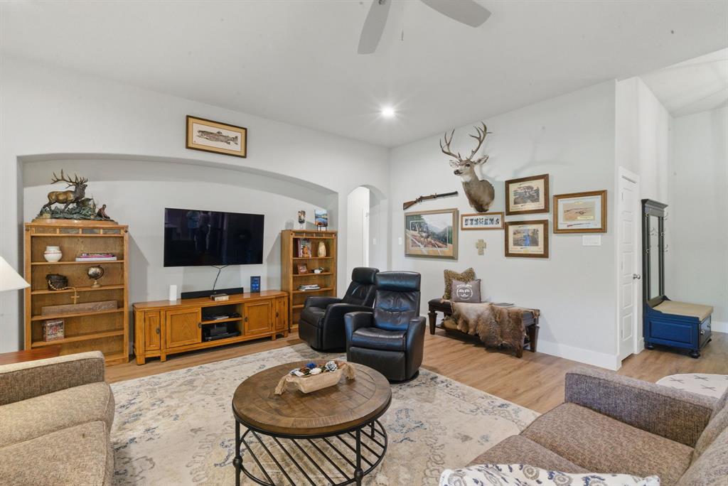 247 Gopher Road Weatherford, TX 76088 - Photo 4 of 35 a living room with furniture a flat screen tv and kitchen view
