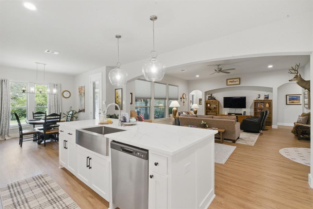 247 Gopher Road Weatherford, TX 76088 - Photo 8 of 35 a large white kitchen with a large island in the center