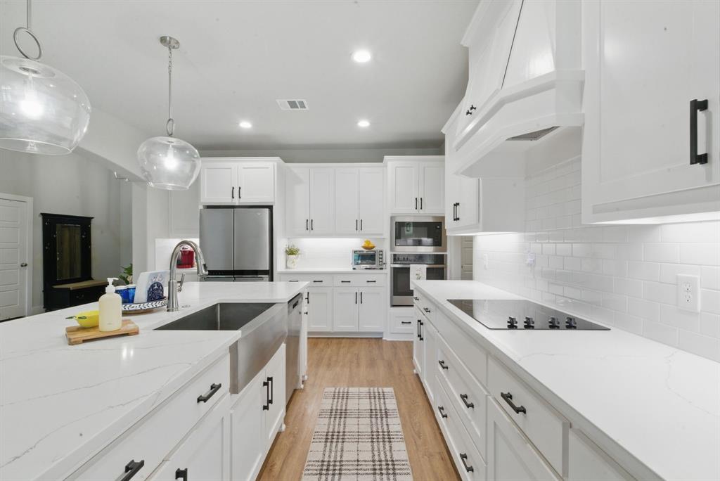 247 Gopher Road Weatherford, TX 76088 - Photo 10 of 35 a kitchen with counter top space a sink stainless steel appliances and cabinets