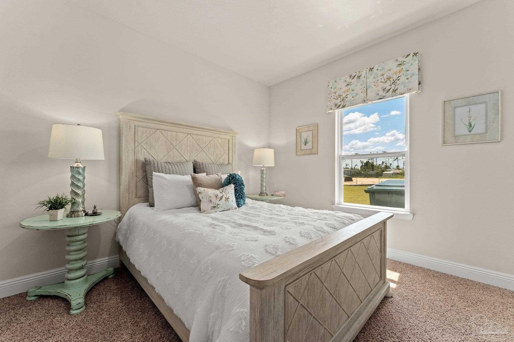 4946 Snipe Road Pace, FL 32571 - Photo 11 of 27 a bedroom with a bed and a table in it