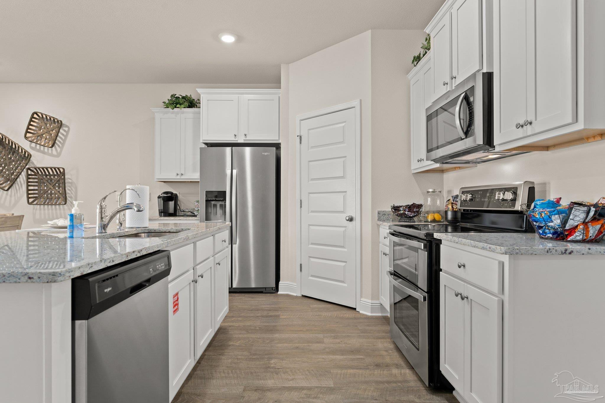 4946 Snipe Road Pace, FL 32571 - Photo 14 of 27 a kitchen with stainless steel appliances granite countertop a refrigerator stove and sink