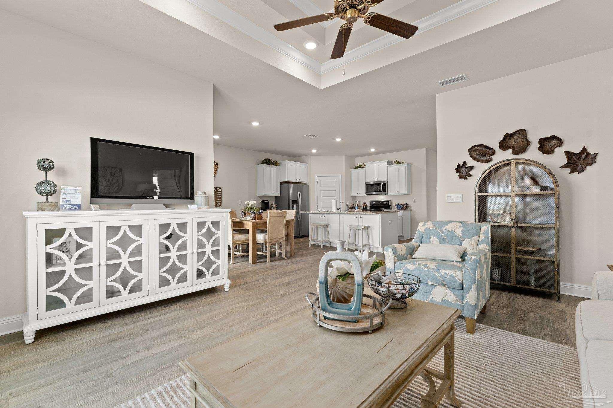 4946 Snipe Road Pace, FL 32571 - Photo 22 of 27 a living room with furniture and a flat screen tv