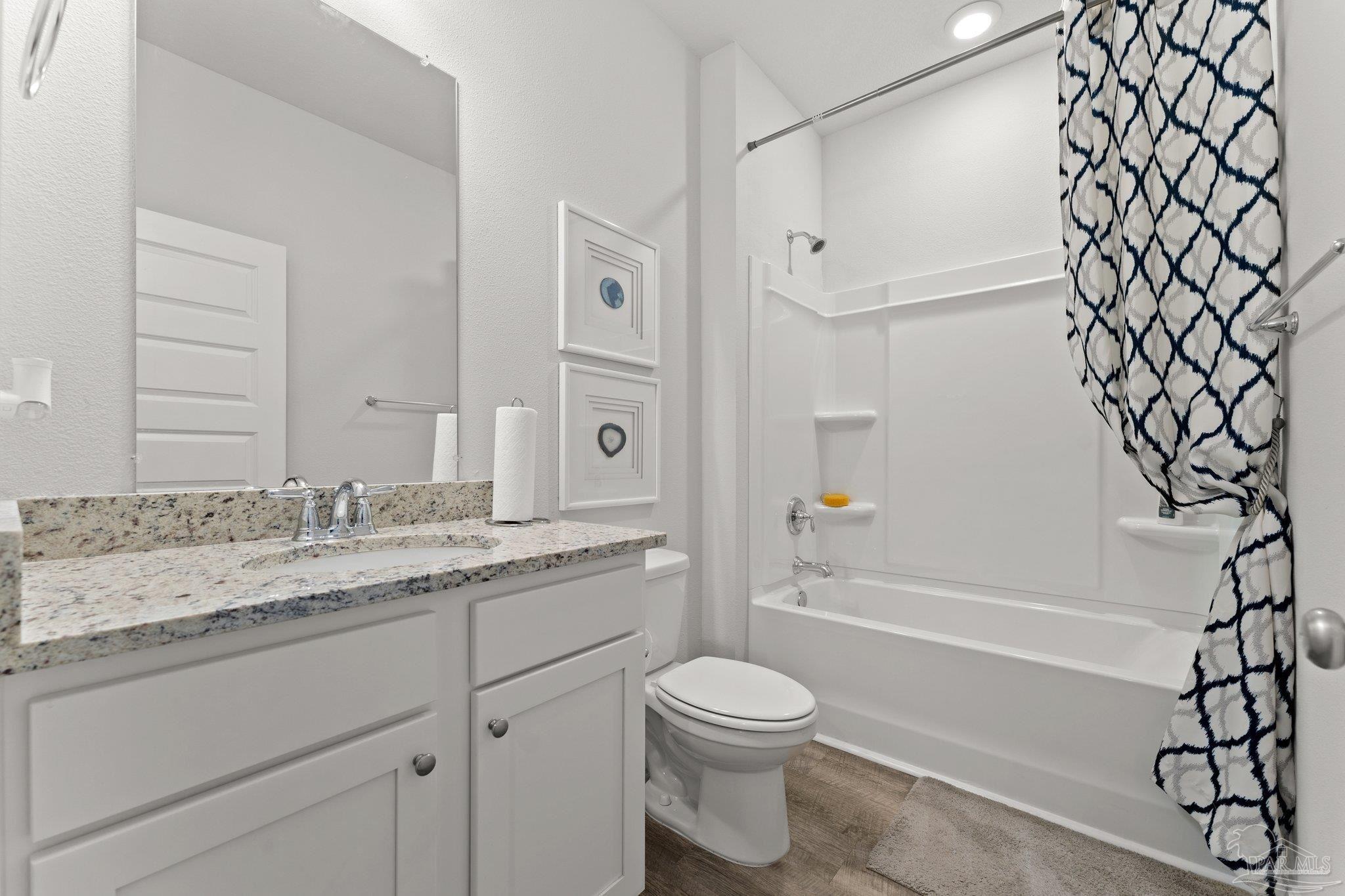 4946 Snipe Road Pace, FL 32571 - Photo 5 of 27 a bathroom with a granite countertop sink toilet and shower
