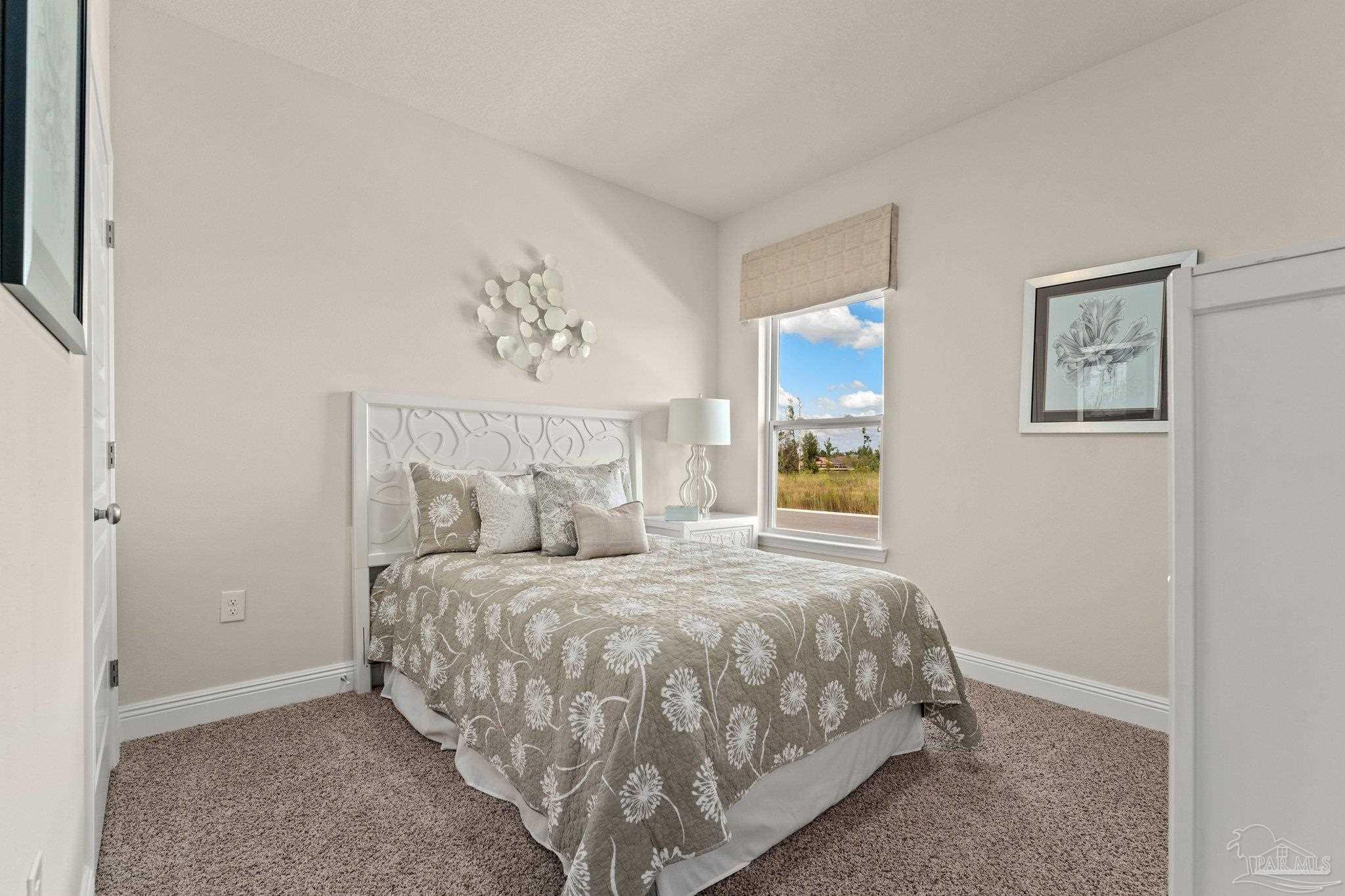 4946 Snipe Road Pace, FL 32571 - Photo 7 of 27 a bedroom with a bed and a painting on the wall