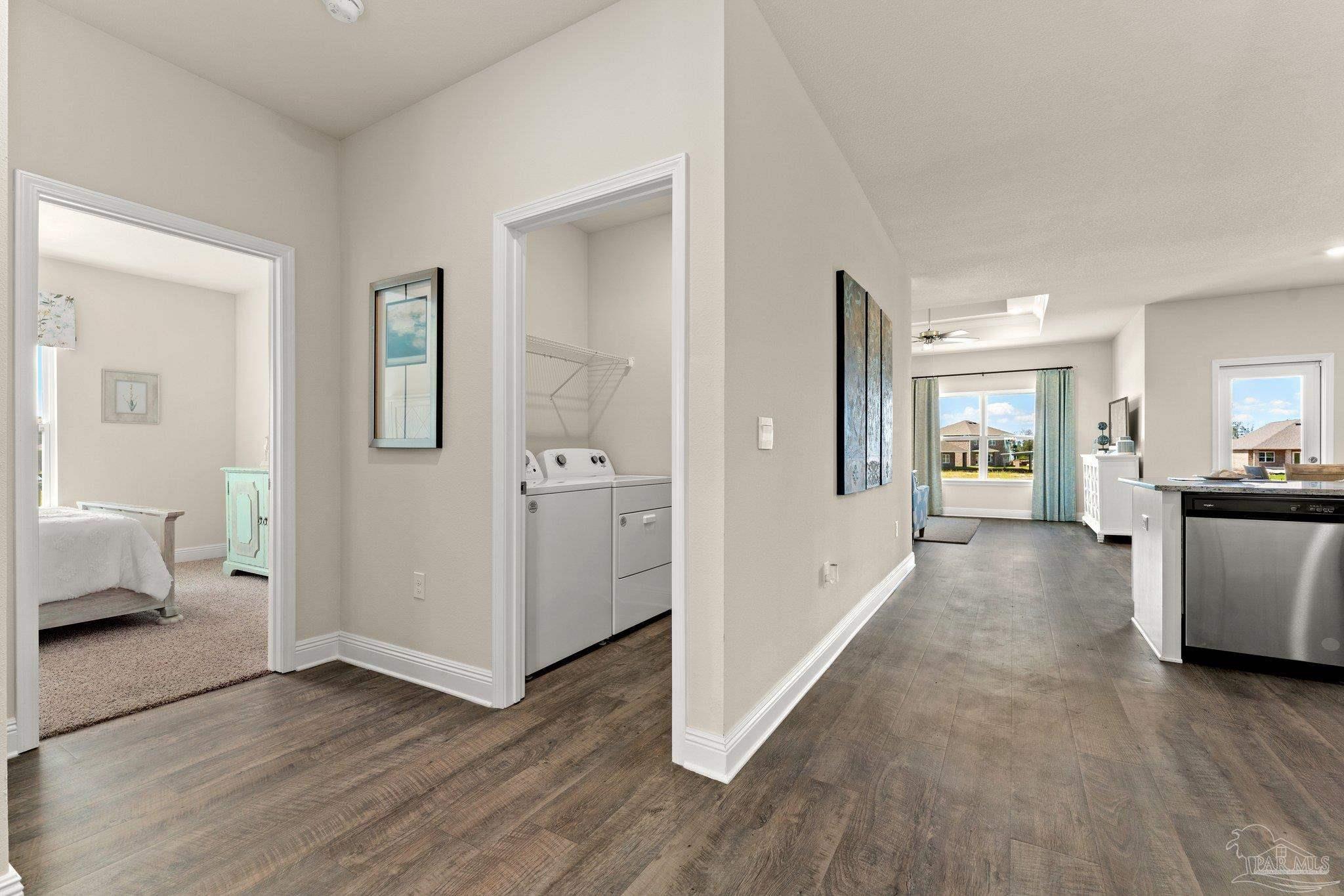 4946 Snipe Road Pace, FL 32571 - Photo 9 of 27 a view of a hallway with wooden floor and a living room