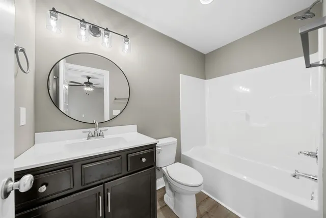 a bathroom with a sink toilet and a mirror