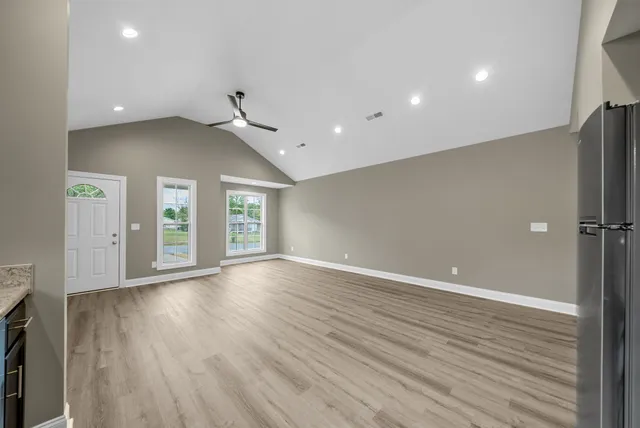 wooden floor in an empty room with a window