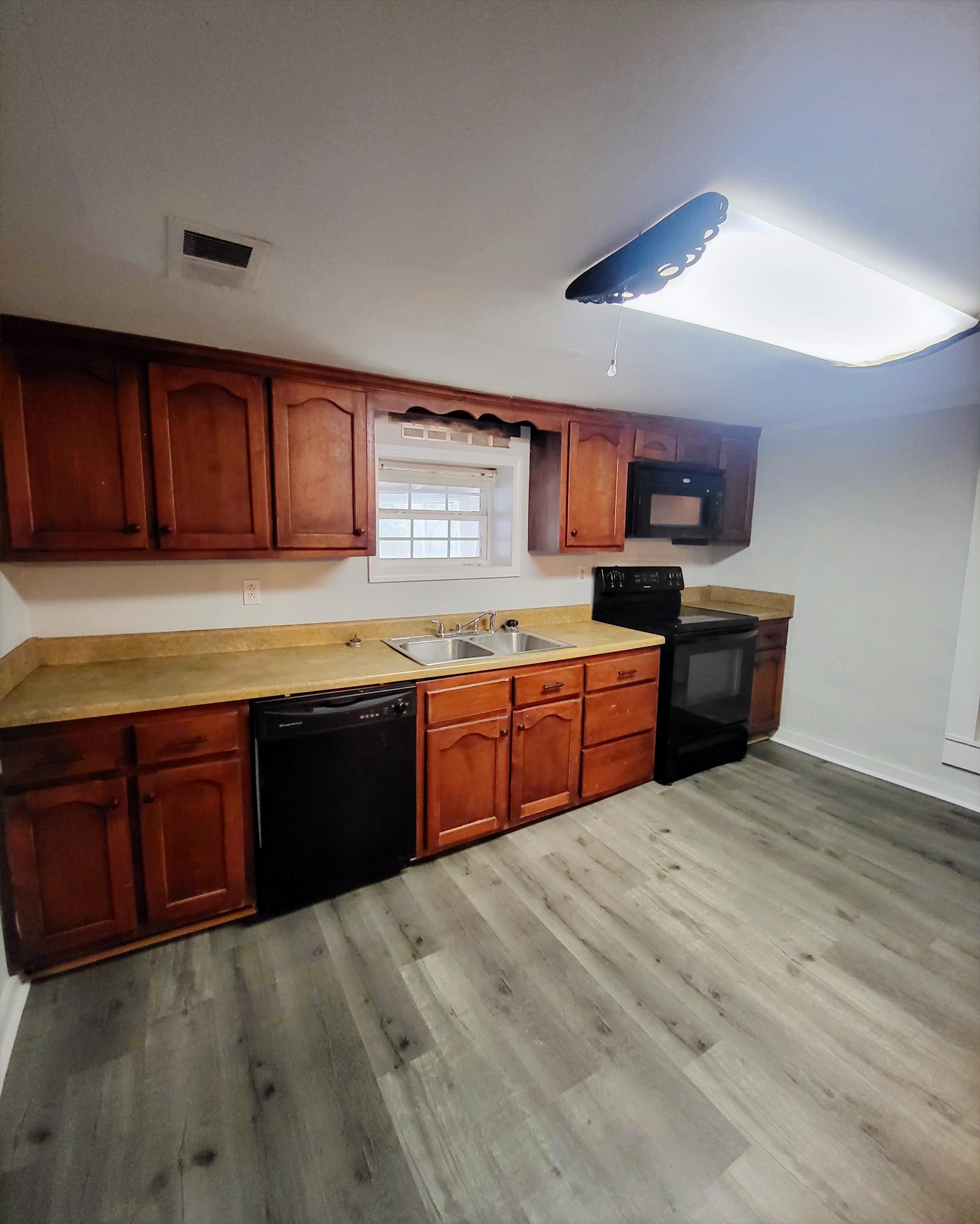 3470 Arp Central Road Ripley, TN 38063 - Photo 14 of 14 a kitchen with stainless steel appliances granite countertop a sink counter space and a window