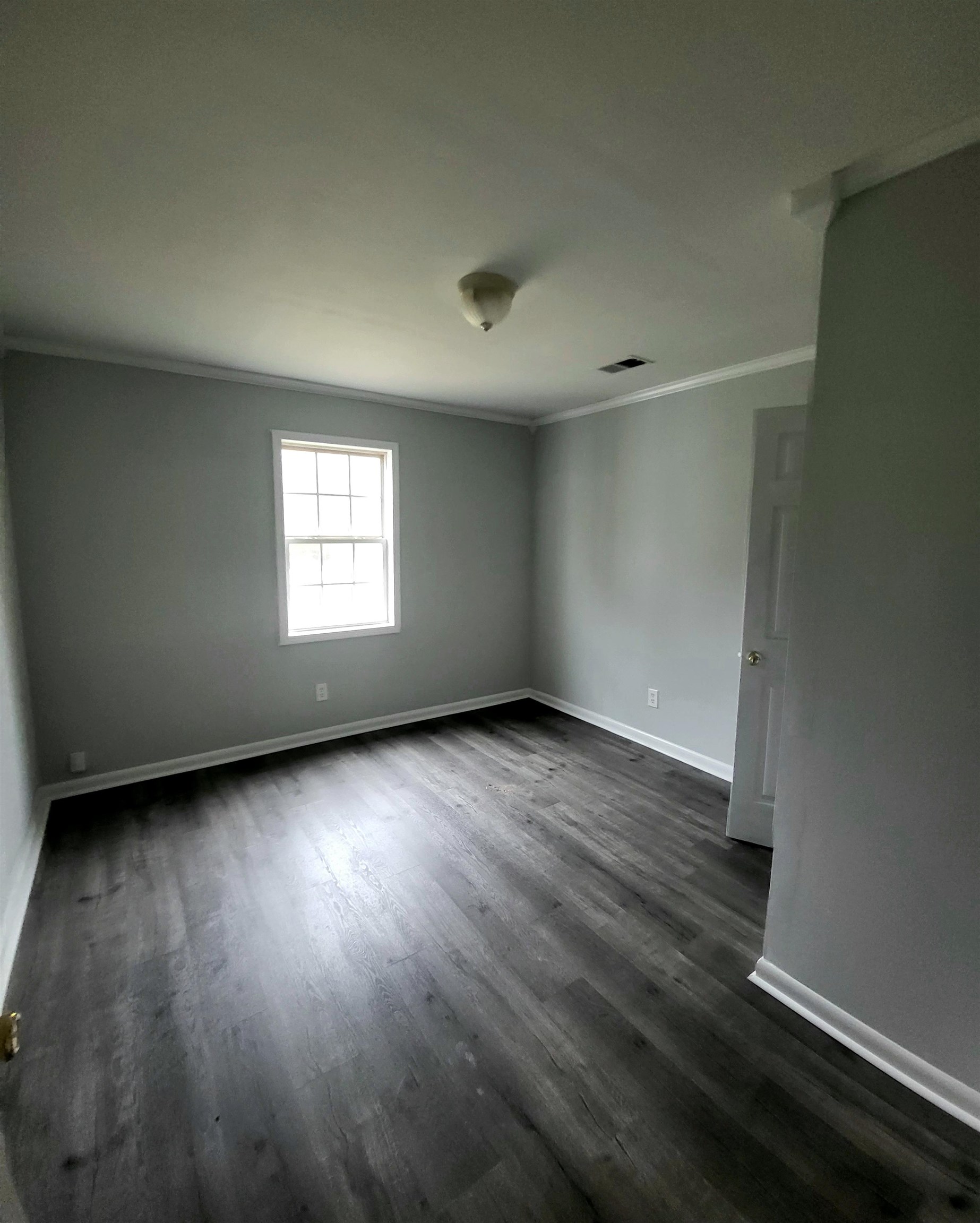 3470 Arp Central Road Ripley, TN 38063 - Photo 10 of 14 an empty room with wooden floor and windows