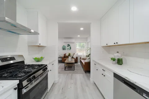 a kitchen with sink stove and cabinets