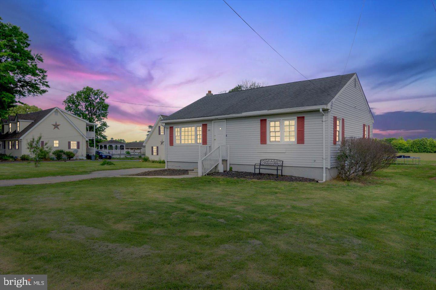 370 South Hook Road Pennsville, NJ 08070 - Photo 1 of 31 Charming home under a vibrant sky.