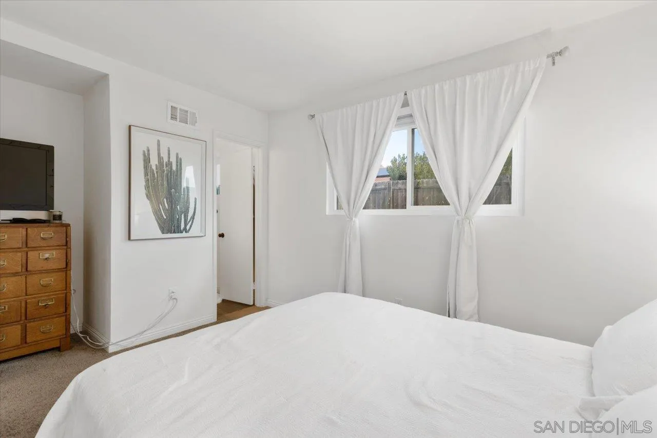 13433 Utopia Road Poway, CA 92064 - Photo 18 of 23 a bedroom with a bed and a flat screen tv
