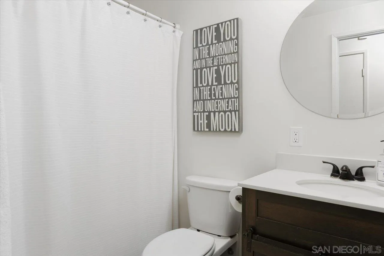 13433 Utopia Road Poway, CA 92064 - Photo 22 of 23 a bathroom with a sink a toilet and a mirror